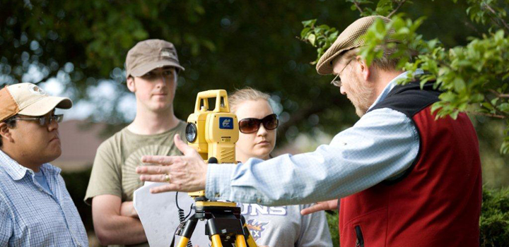 Professor and students working outside