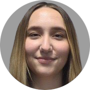 A close-up photo of a young woman
										with a fair complexion and straight,
										long, blonde hair parted in the middle.
										The individual has a gentle smile and
										is looking directly at the camera.
										The background is a simple grey color.