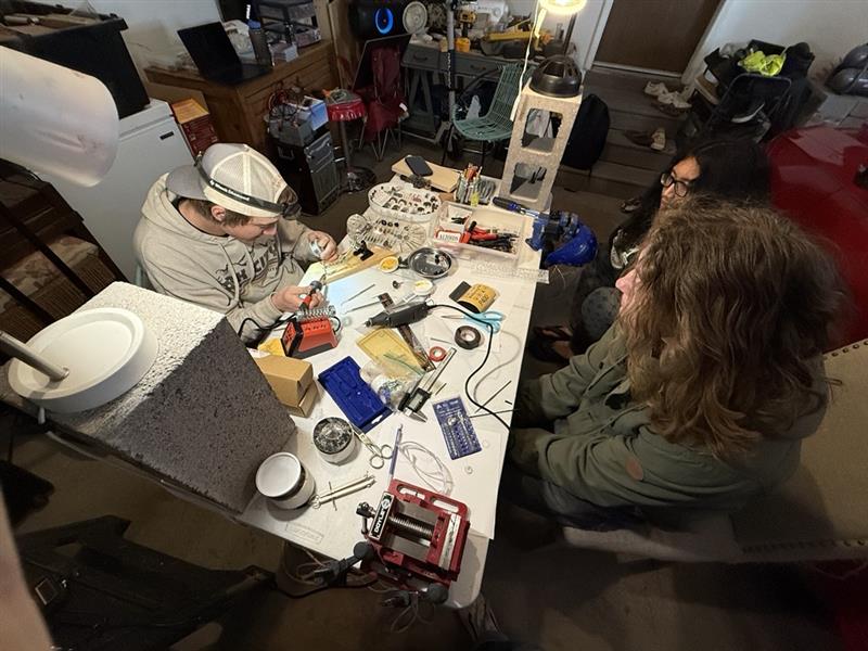 Build status photo showing chamber assembly and supporting hardware in development.