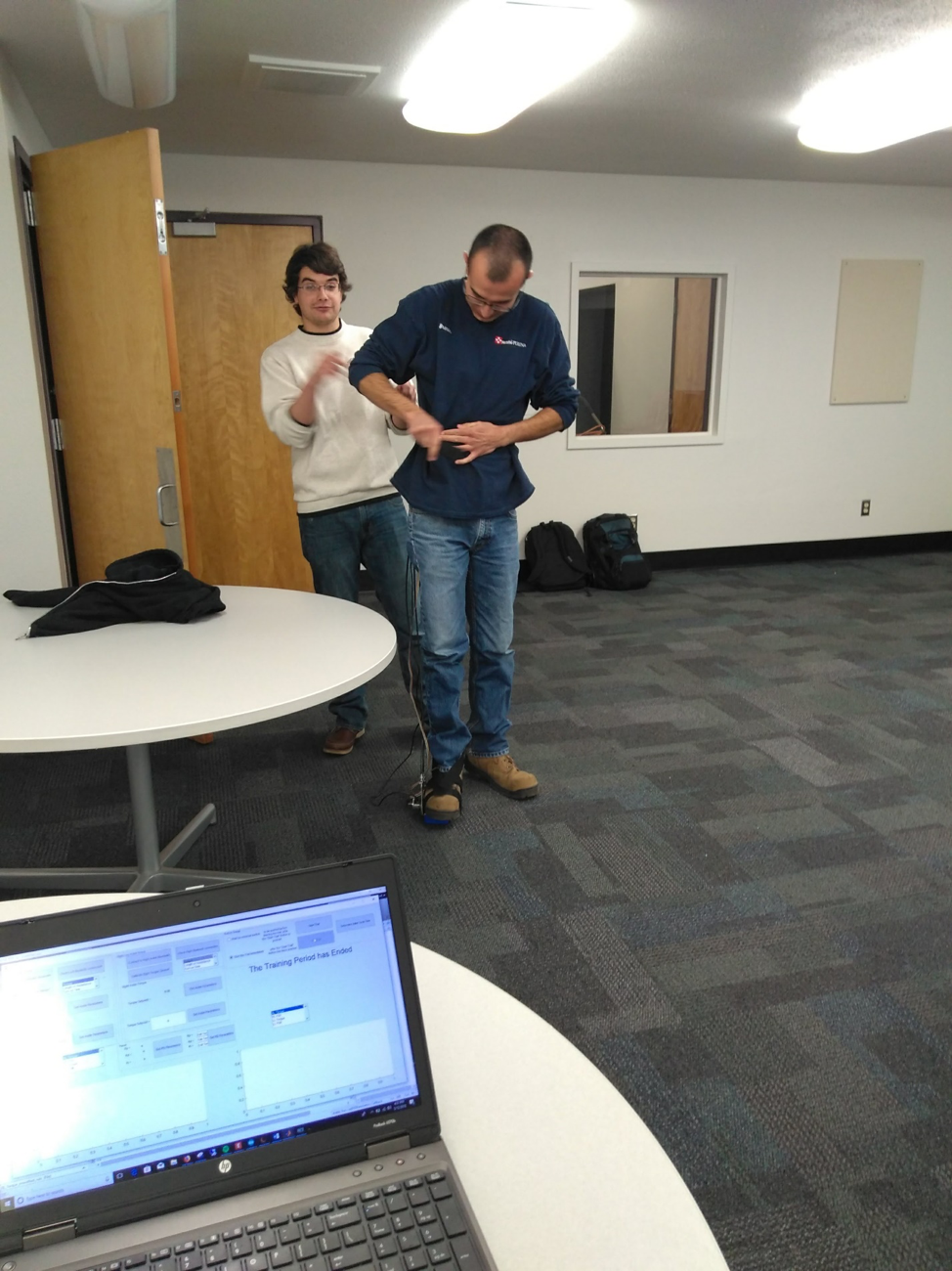 Robert Libby and Brandon Begay having a fun time, trying to put the exoskeleton on for testing.