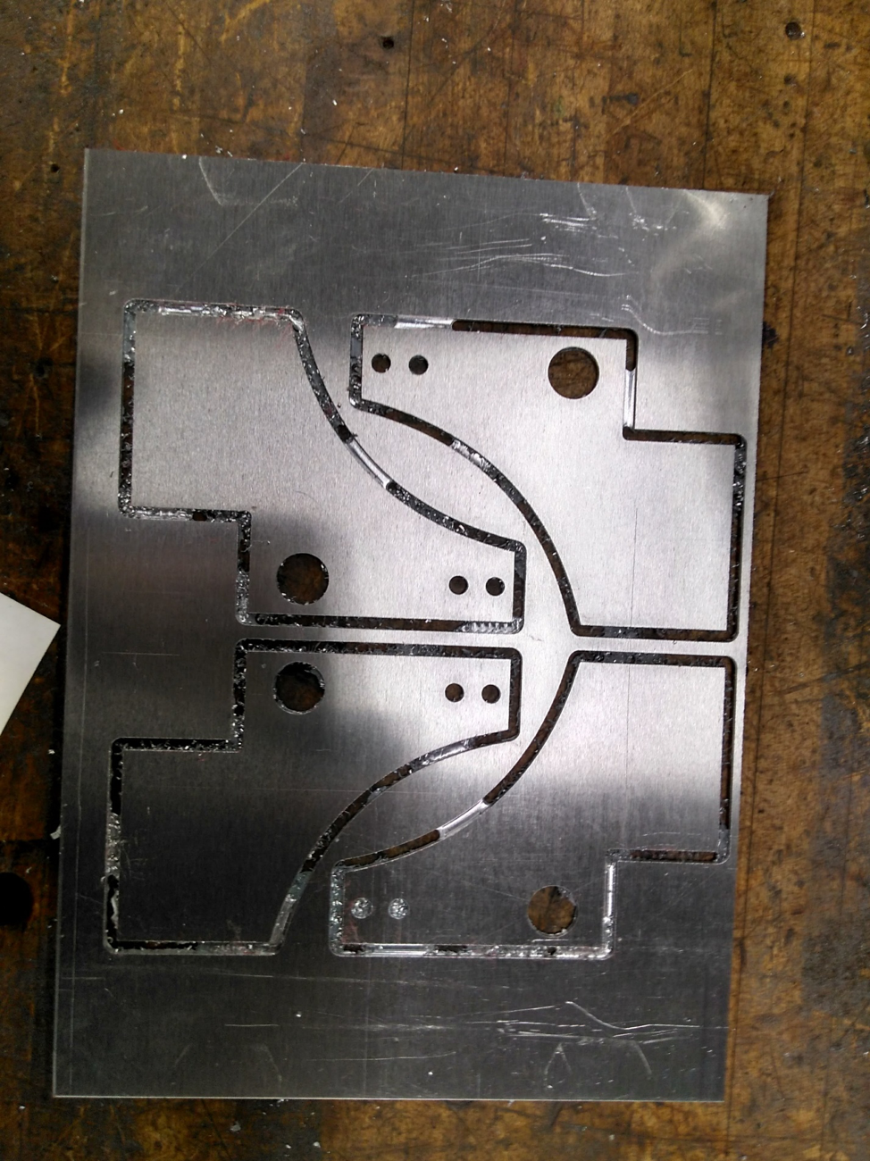 The CNC'd cutouts of the L-bracket, these were then chipped out of the sheet and bent to make the finished product!