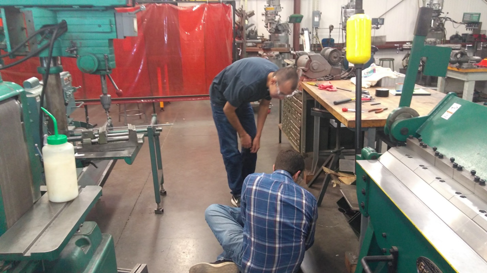 Robert Libby and Brandon Begay doing something mysterious in the machine shop.