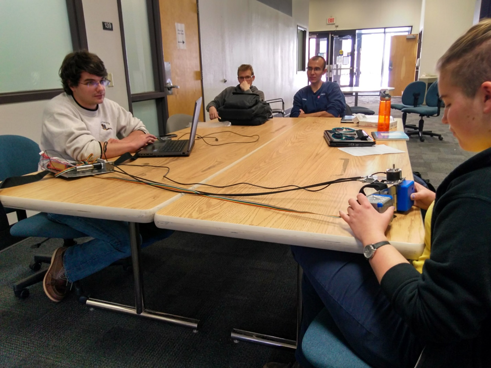 The entire team, all together, doing some benchtop testing. Left to right: Robert Libby, Ethan Michel, Brandon Begay, Azalea Grant.